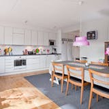 Scandinavian white kitchen with pink pendant lamps